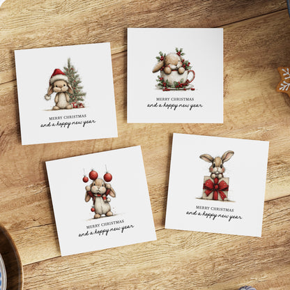 Four bunny-themed Christmas greeting cards with "Merry Christmas and a Hoppy New Year" text on a wooden surface