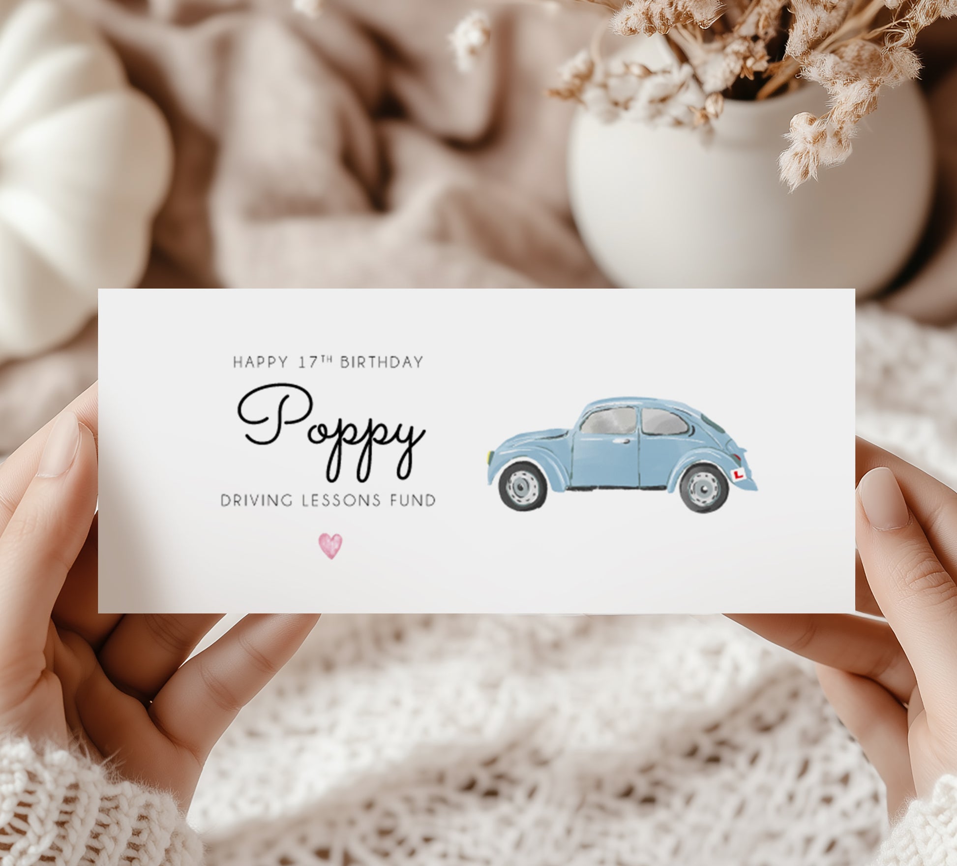 Hands holding a birthday money wallet. Text reads "Happy 17th Birthday (name) Driving Lessons Fund" Featuring a blue VW beetle car Illustration with a L plate. 