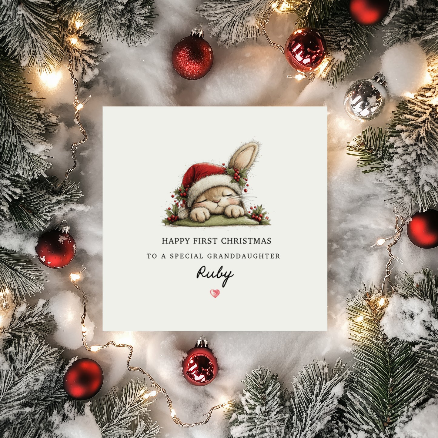 Personalised first Christmas card with a bunny wearing a Santa hat. Text reads "Happy First Christmas To a special (relationship) (name) surrounded by festive decorations.