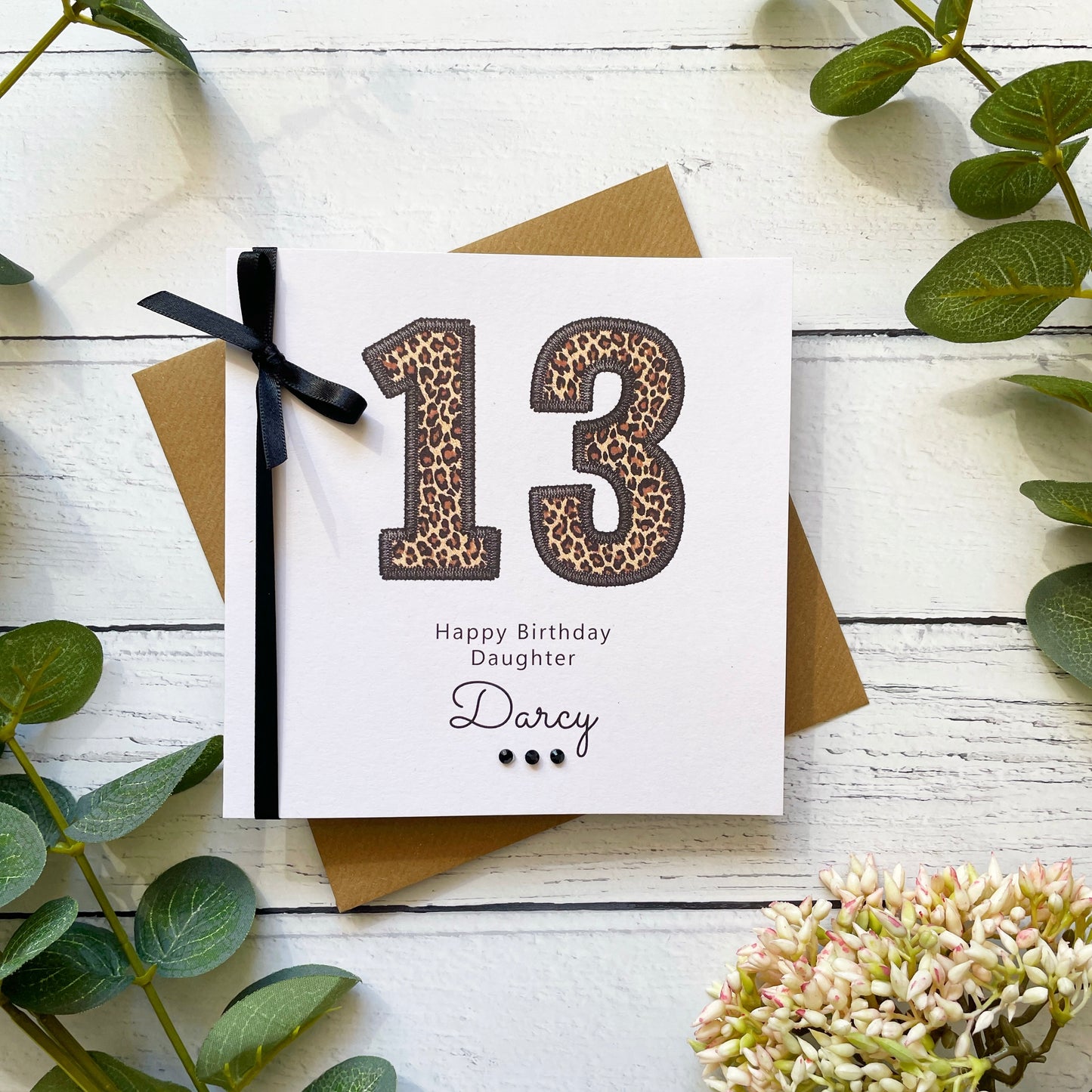 Birthday card for a 13-year-old daughter with leopard print numbers on a white background.