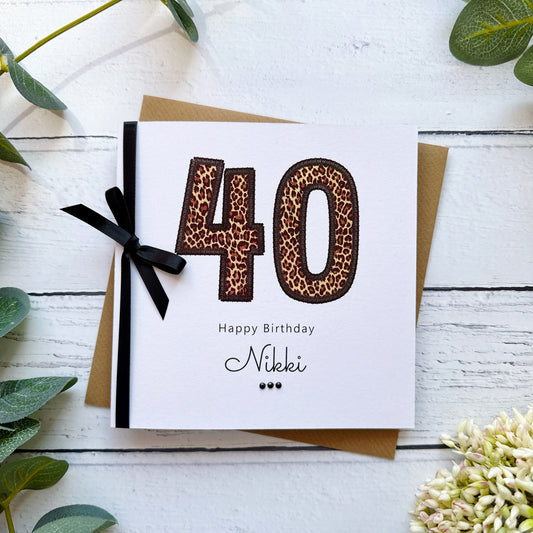 Birthday card with leopard print numbers '40' and a black bow on a white background.