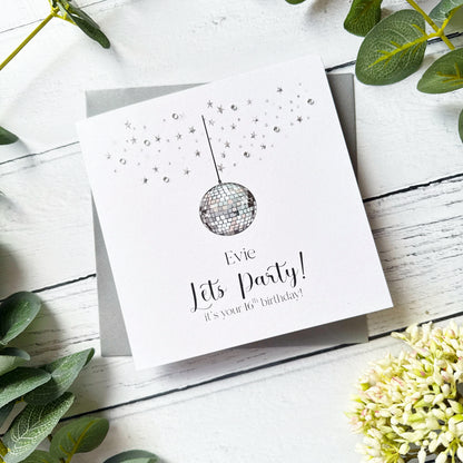 Birthday card with disco ball design with personalised text on a wooden surface with greenery