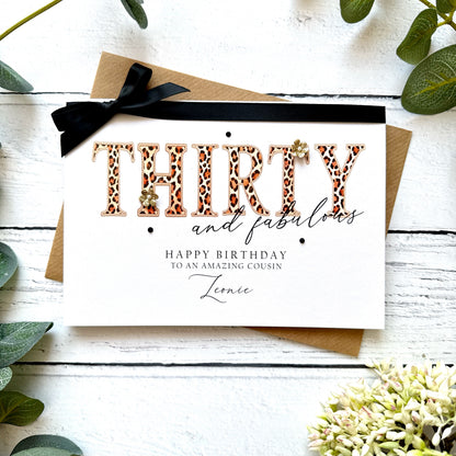 Birthday card with leopard print text 'THIRTY and fabulous' on a white background with greenery.