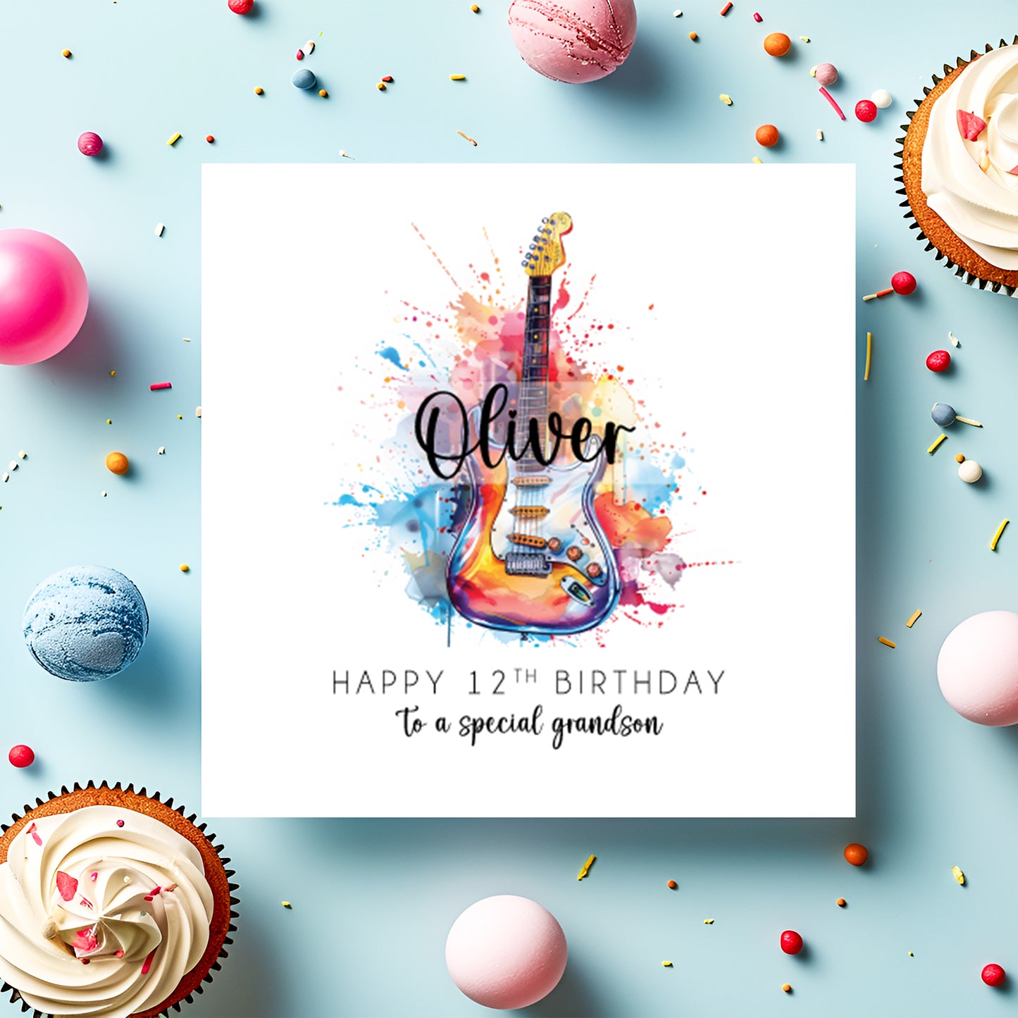 Greeting card with colorful guitar illustration and birthday message on a blue background with cupcakes and candies.