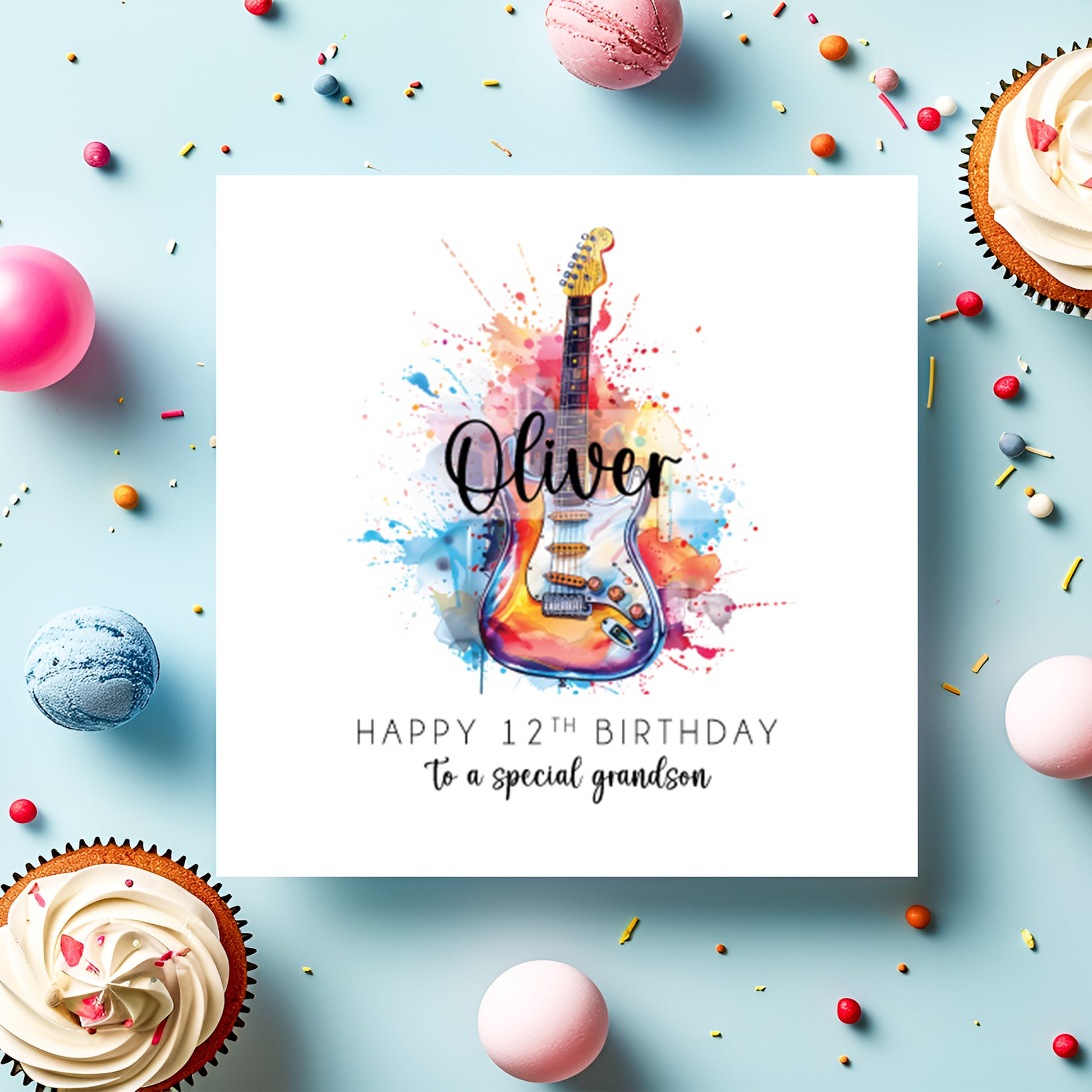 Greeting card with colorful guitar illustration and birthday message on a blue background with cupcakes and candies.