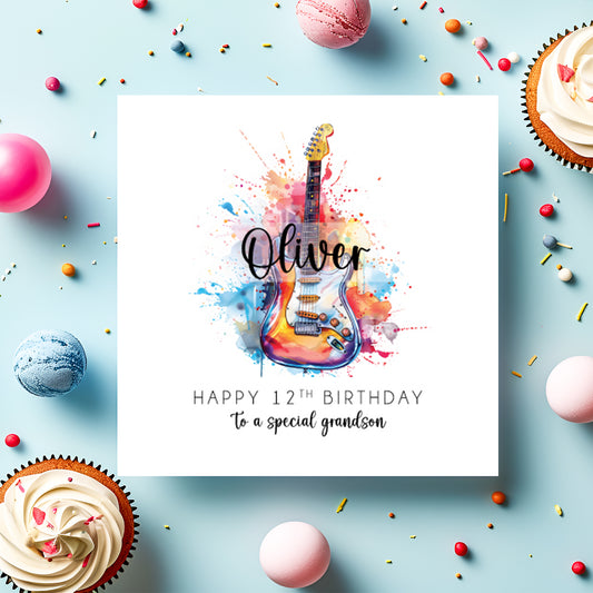 Greeting card with colorful guitar illustration and birthday message on a blue background with cupcakes and candies.