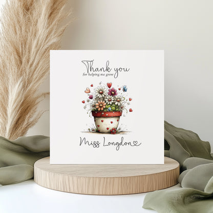 Thank you teacher greeting card with floral design and personalised text on a wooden stand with decorative elements.