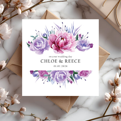 Wedding card with pink and purple floral design and personalised text