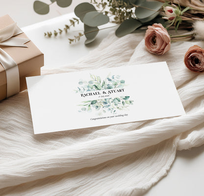 Sage green Wedding money wallet with greenery design with couples name and wedding date on a soft fabric background