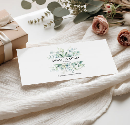 Sage green Wedding money wallet with greenery design with couples name and wedding date on a soft fabric background