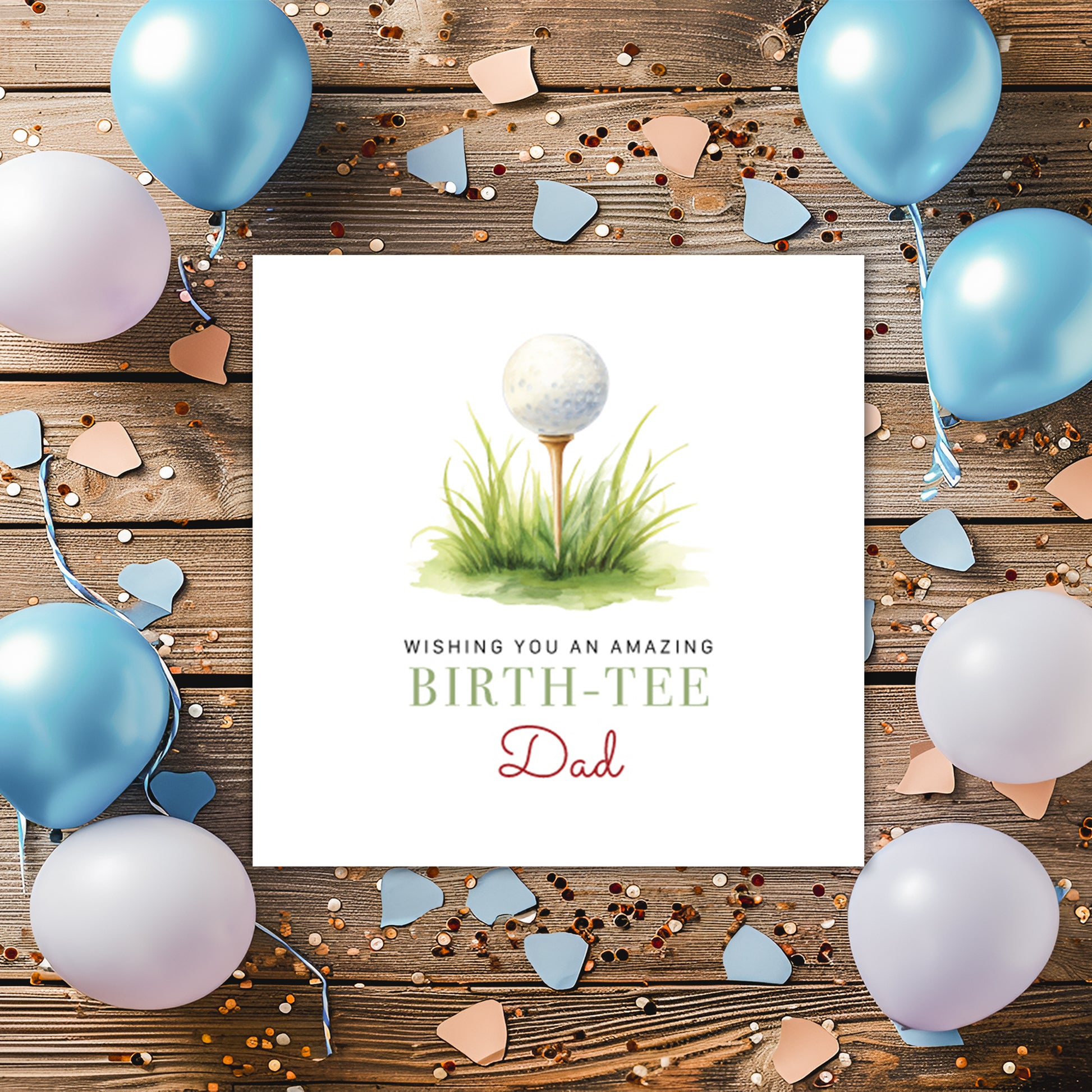 Greeting card with golf ball and tee design, surrounded by balloons and confetti on a wooden background.